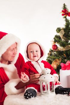 Christmas baby and mom under the fir tree isolated