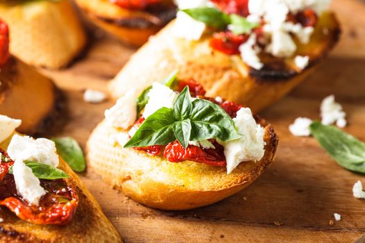 Bruschetta with olive oil, sundried tomatoes, feta and fresh basil