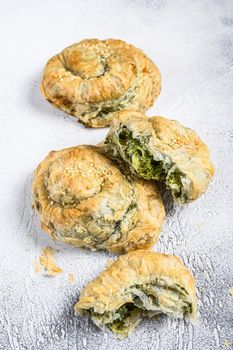 Spinach and feta cheese Twist greek Pie puff. White background. Top view.