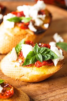 Bruschetta with olive oil, sundried tomatoes, feta and fresh basil