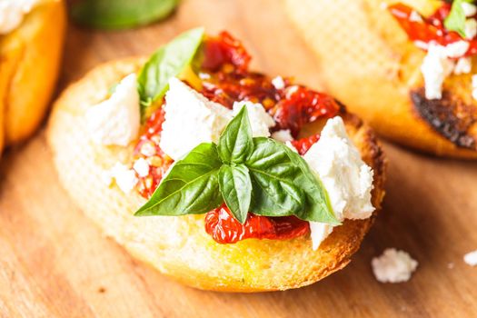 Bruschetta with olive oil, sundried tomatoes, feta and fresh basil