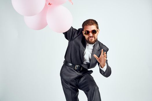 business man pink balloons office party light background. High quality photo