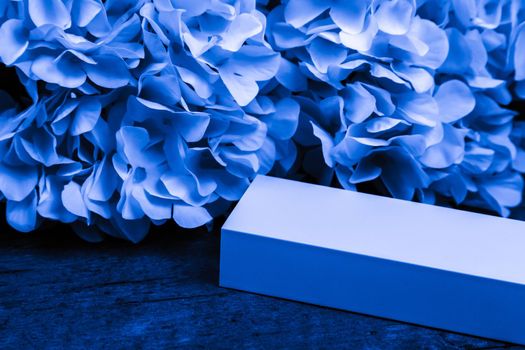Gift or present box and flower in a trendy classic blue color. Greeting card.