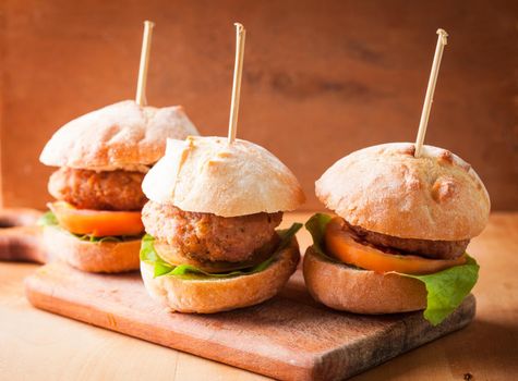 mini burgers with tomato, lettuce and meat cutlet