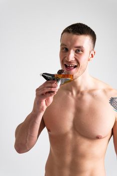Man eats protein bar on white background isolated bar nutrition holding athlete smiling wellness, isolated handsome. People outdoor granola, muesli female