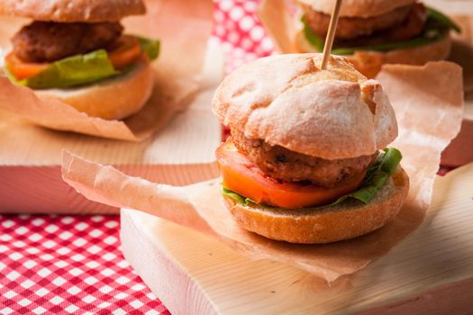 mini burgers with tomato, lettuce and meat cutlet