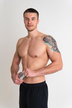 Male drink-water fitness is pumped with a towel on a white background isolated strong lifestyle, training young bottle guy, break Towel copy active, tired one muscle