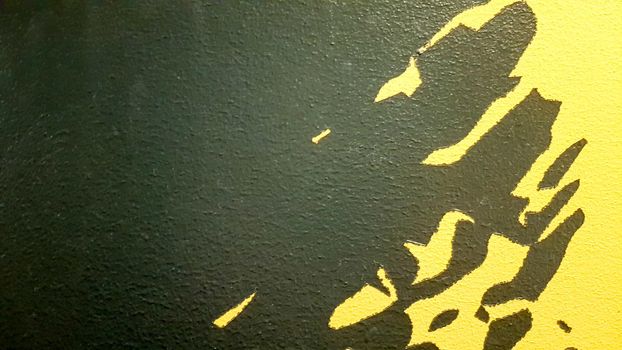 Black abstract paint splashes dripping on a bright yellow background. Black paint splashes on a yellow background. concept of art ideas. Paint brush texture yellow and black on background.