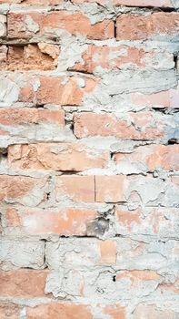 Background of red brick wall near pattern texture. A sample photo of a vertical wall with bricks and cement. Vertical photo for social networks