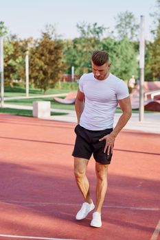 athletic men doing exercises on the sports ground in summer. High quality photo