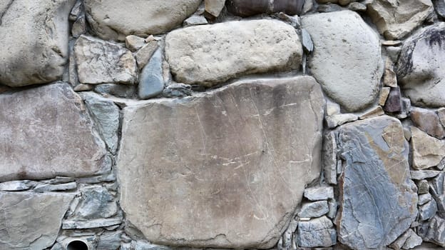 The texture of the stone wall. Old castle stone wall texture background. Stone wall as a background or texture. Part of a stone wall, for background or texture. pattern gray color modern style design.