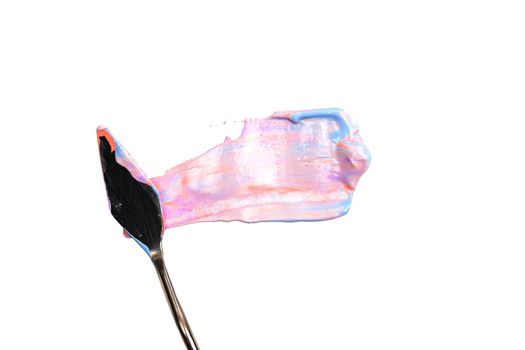 a painting palette knife isolated on a white background painting a pink and violet with copy space
