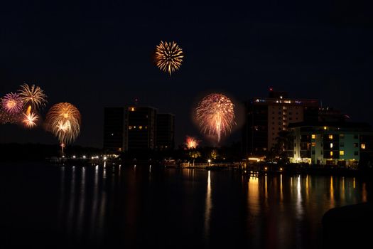 Fireworks over skyline over Hickory Pass leading to the ocean in Bonita Springs, Florida.