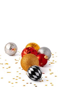 Pile of Christmas baubles isolated on white background, close up