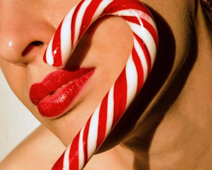 young woman with christmas striped candy cane