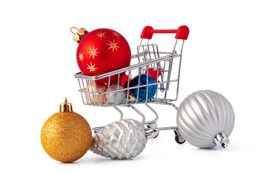 Shopping cart with Christmas decorations isolated on white background, close up
