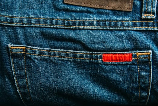 Pocket of blue jeans denim pants closeup.