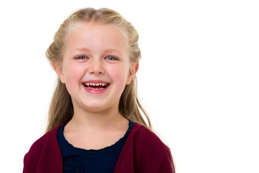 Portrait of happy laughing girl. Close up shot of cute blonde smiling little child smiling looking at camera against white background. Happy childhood concept