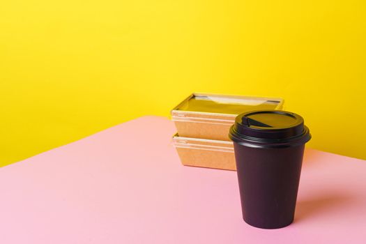 Takeaway food concept. Some packed food in container with coffee cup on table