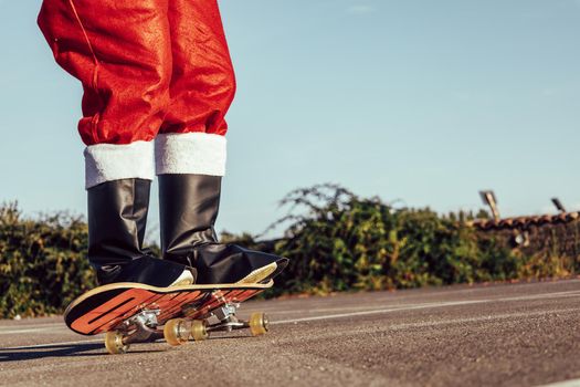 Santa claus skateboarding, close up, copy space