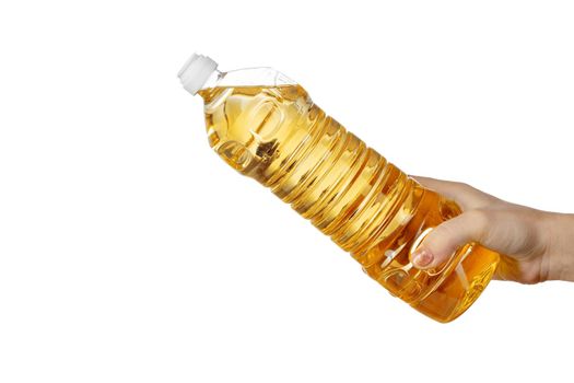 Hand of woman pouring cooking oil from plastic bottle. Isolated on white background. Close up.