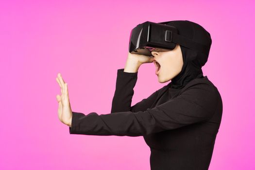 muslim woman wearing virtual reality glasses entertainment technology device. High quality photo