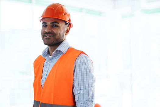 Portrait of young construction engineer wearing hardhat, close up