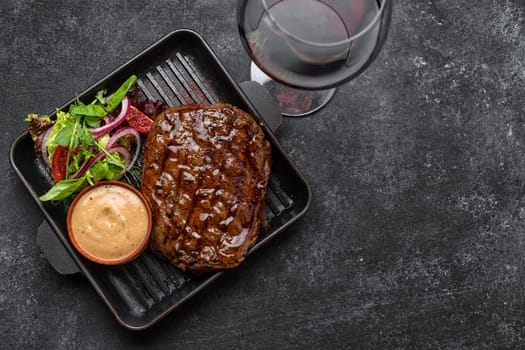 steak with salad and sauce on a blackboard