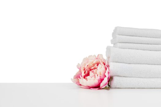 Spa composition with towels and flowers isolated on white background