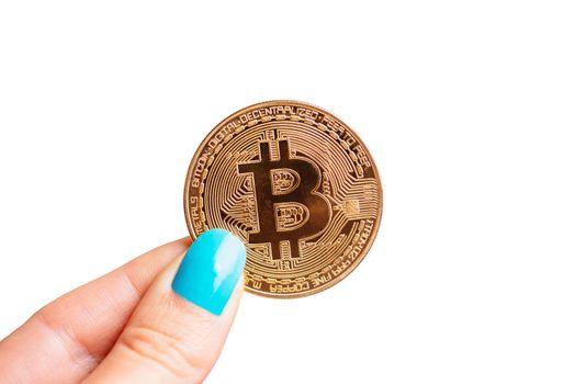 Female hand holding gold coin bitcoin on a white background, symbol of crypto currency and virtual money.