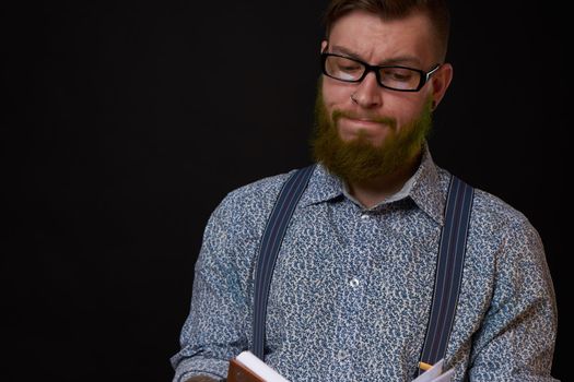 man in glasses with a notebook in his hands training professional office. High quality photo