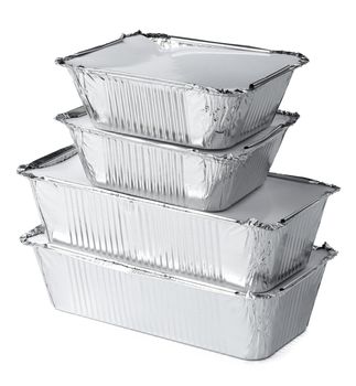 Packed foil food boxes on white background, copy space, close up