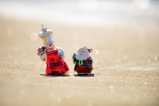 Christmas holiday concept. Toy snowman on the sea. Summer New Year