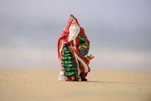 Santa Claus, tropical vacations concept. Christmas or New Year decoration on sea beach background with copy space