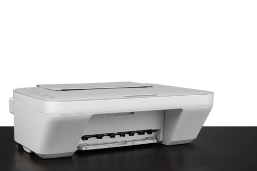 Laser home printer on table against white background, close up