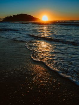 Sunrise on the beach and ocean waves on a tropical sea. High quality photo