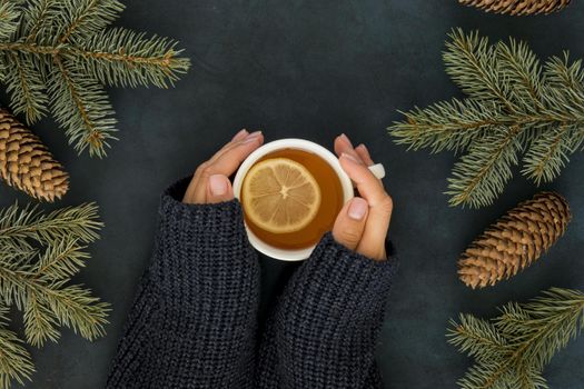 cute winter concept with woman holding cup of tea