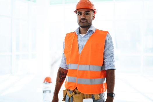 Portrait of young construction engineer wearing hardhat, close up