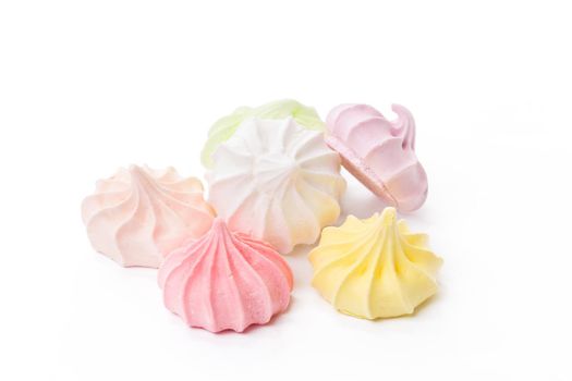 Pile of colorful meringue cookies isolated on white background