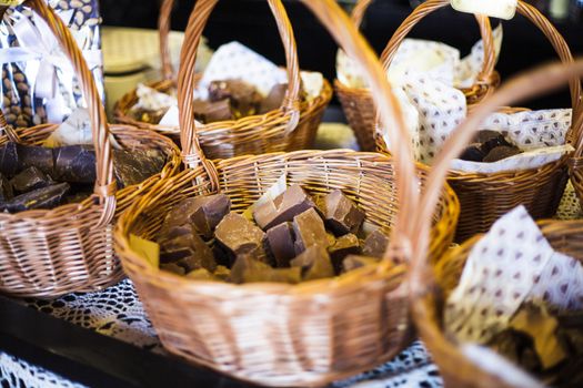 Chocolate shop. Pieces of natural product in baskets