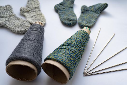 Socks, thread, needles are on white background, isolated, knitting concept.