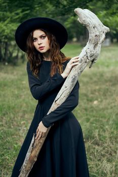 woman in witch costume fantasy magic forest posing. High quality photo