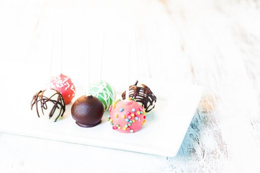 Cake pops close up on the white plate