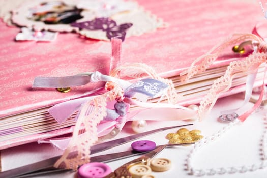 Making scrapbooking album with rings and decorations on the table and tools