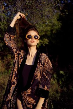 pretty woman in fashionable clothes sunglasses nature posing. High quality photo