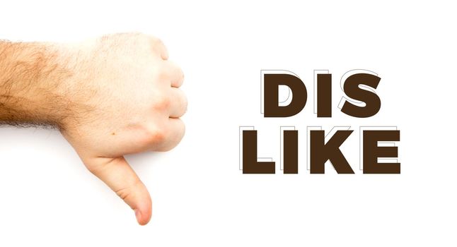 Male hairy hand showing Dislike, unlike, fail, disagree sign, thumb down hand with white background and copy space.