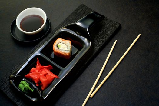 Sushi rolls top view. Stylish minimalism in the menu. Serving rolls to the client in a dark style. The kit is ready for lunch