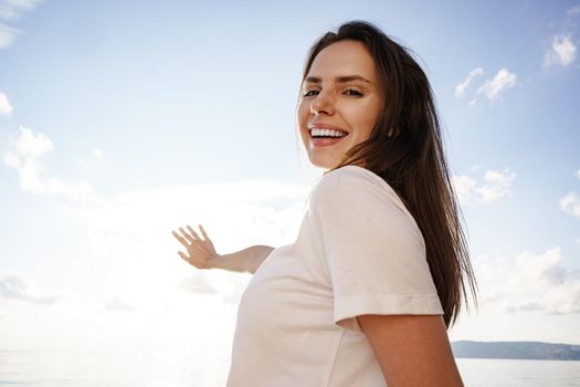 Portrait of young beautiful woman standing on boat against sea backgorund, close up