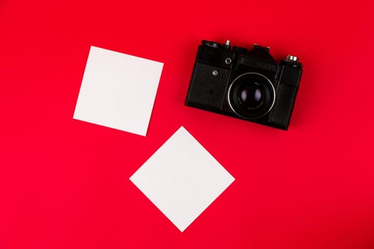 Flat lay film camera isolated on red background. Copy space