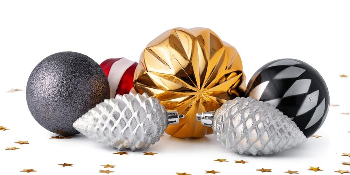 Pile of Christmas baubles isolated on white background, close up